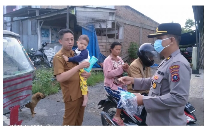 Kepala bagian Ops Polres Samosir langsung Turun Ke Jalan Bagikan Masker Gratis.